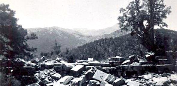 black and white photographs of ruins in front of trees and mountains